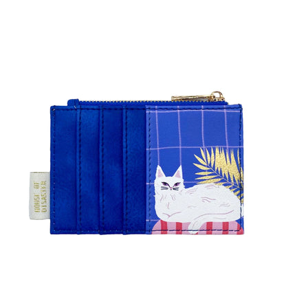 A quirky accessory, this blue cat purse includes a zipped pocket and depicts a white cat lounging on pink beside gold leaves, ideal as an unusual gift for cat lovers.