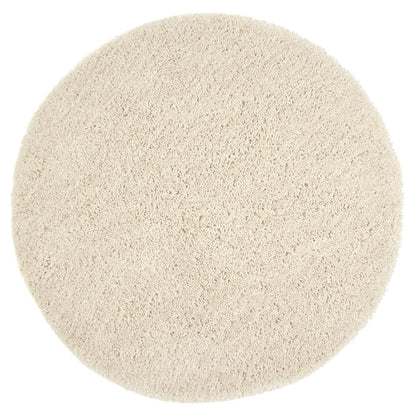 A circular, beige, hand-tufted shaggy pile rug seen from above against a white background.