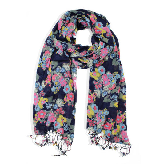 A deep blue floral scarf with a colourful pattern and fringed ends is shown against a white background. This soft scarf is ideal for adding vibrant flair to any outfit.