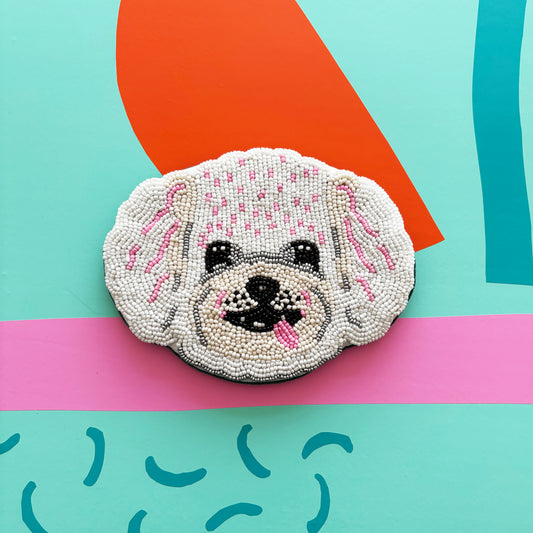 Beaded patch featuring a white poodle with pink accents, set against a colourful, abstract background—ideal for adding flair to your beaded coin purse or Dog House Coin Purse collection.