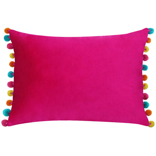 Vivid pink Fiesta Velvet Cushion featuring multicoloured pom-poms along the edges—this plush cushion is designed for both style and comfort.