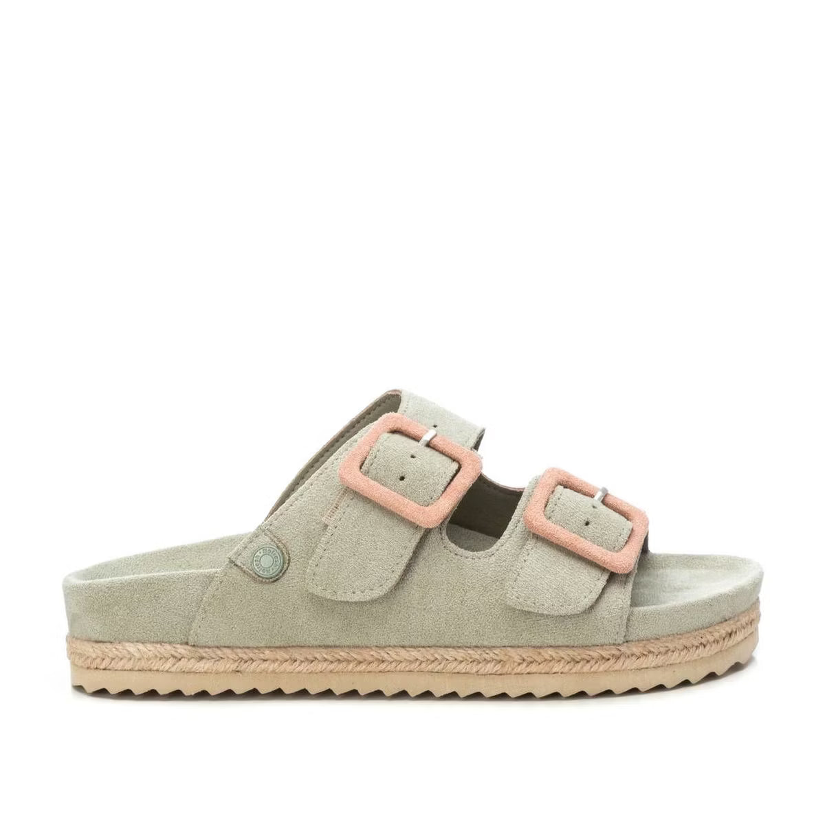 Light beige vegan suede sandals with a flatform sole, featuring two straps with pink buckles and a flat sole finished with braided trim and a textured underside.