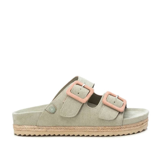 Light beige vegan suede sandals with a flatform sole, featuring two straps with pink buckles and a flat sole finished with braided trim and a textured underside.