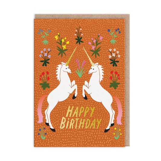 Birthday card featuring two unicorns facing each other on an orange background, surrounded by vibrant meadow flowers. The words Happy Birthday grace the centre, adding a touch of floral imagery to your special day.