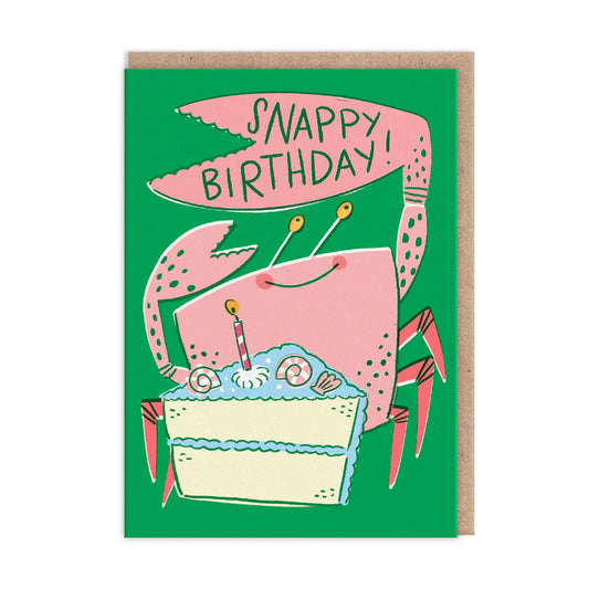 A cartoon crab holds a cake with a candle against a green backdrop. The text reads Snappy Birthday! on this delightful Hello!Lucky birthday card.