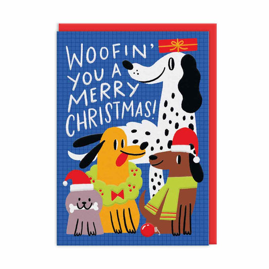 Illustrated Christmas card featuring three dogs and a cat in festive outfits on a blue background—ideal as a jolly Christmas present for dog lovers! Text reads: Woofin you a Merry Christmas!.