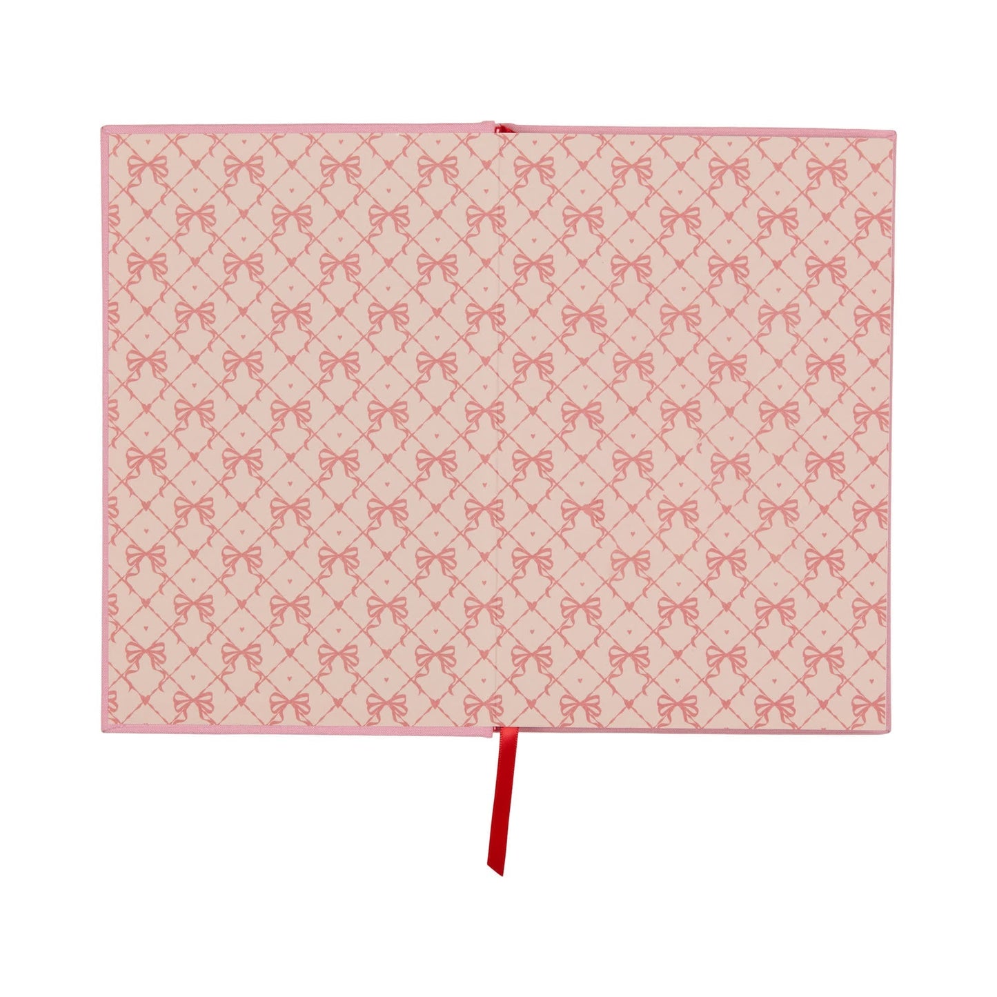 An open lay-flat journal with pink covers and pages displaying a repeating pattern of red bows, along with a red ribbon bookmark positioned in the centre.