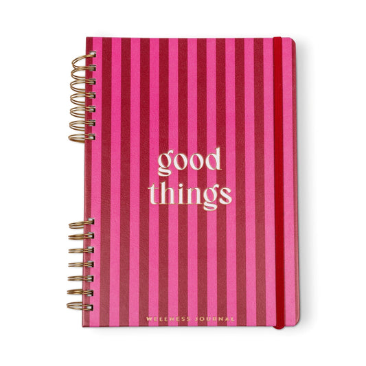 A spiral-bound self-care journal featuring pink and red vertical stripes and the words good things on the cover, ideal for your daily gratitude practice.