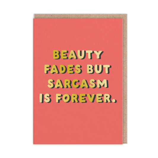 An A6-sized Sarcasm Greeting Card showcases bold, playful lettering with Beauty fades but sarcasm is forever against a striking red background. Ideal for any occasion, it includes a blank interior for your personal message.