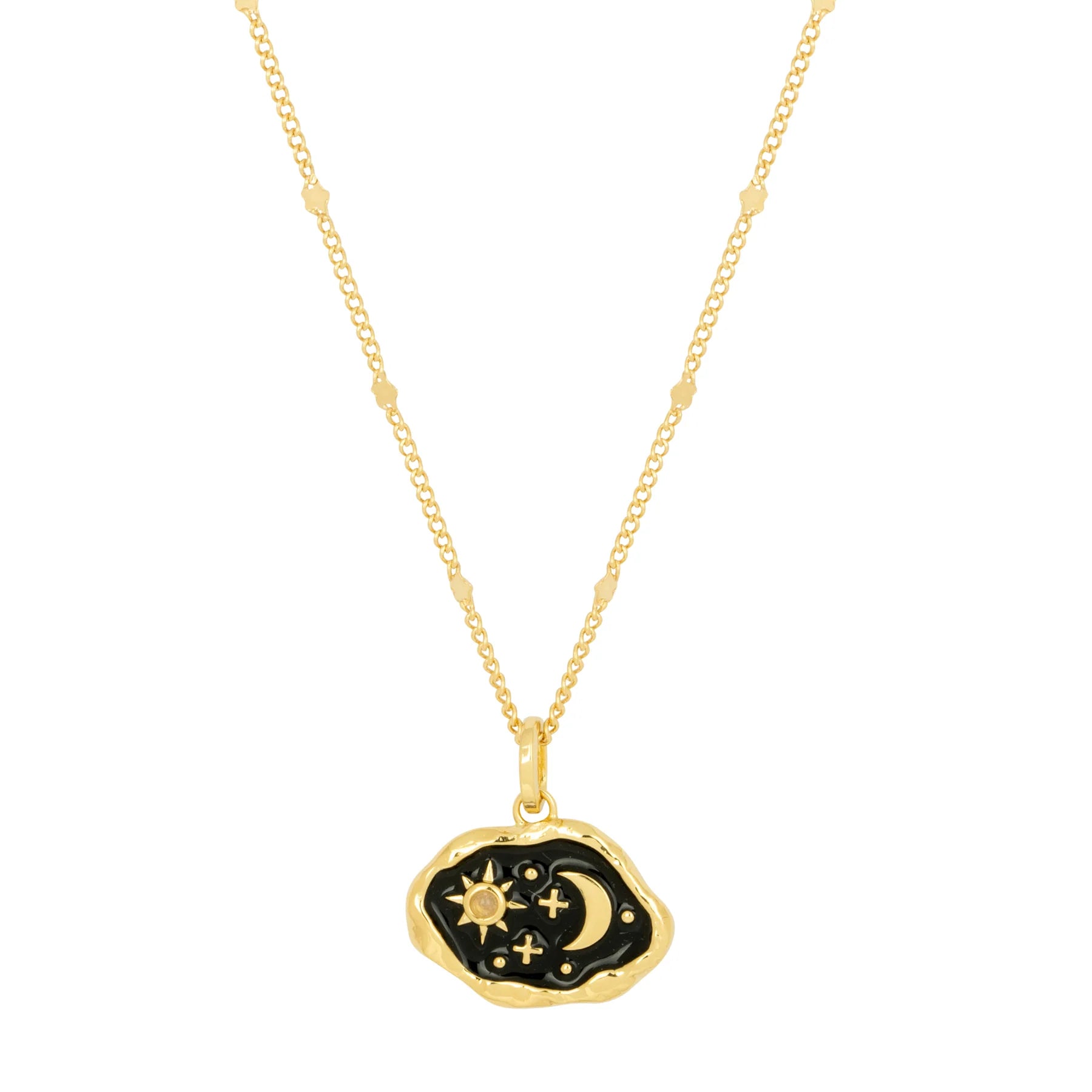 Gold statement necklace with a pendant showcasing a black enamel background adorned with gold sun, moon, and stars, on a delicate beaded chain.