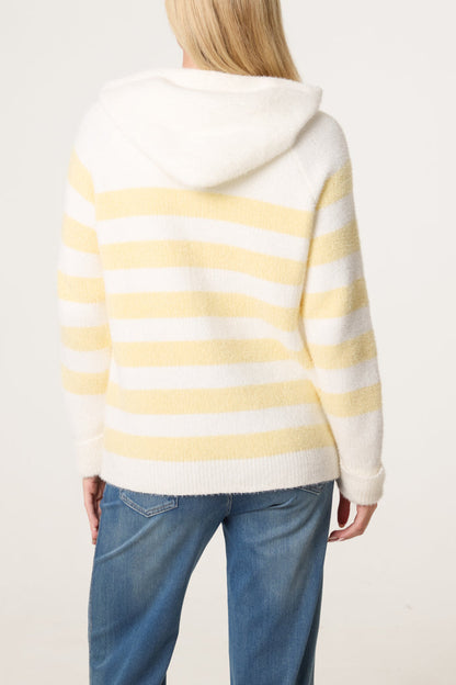 Person wearing a zip-up cosy striped hoodie in white and pale yellow with blue jeans, displayed from the back against a plain background.