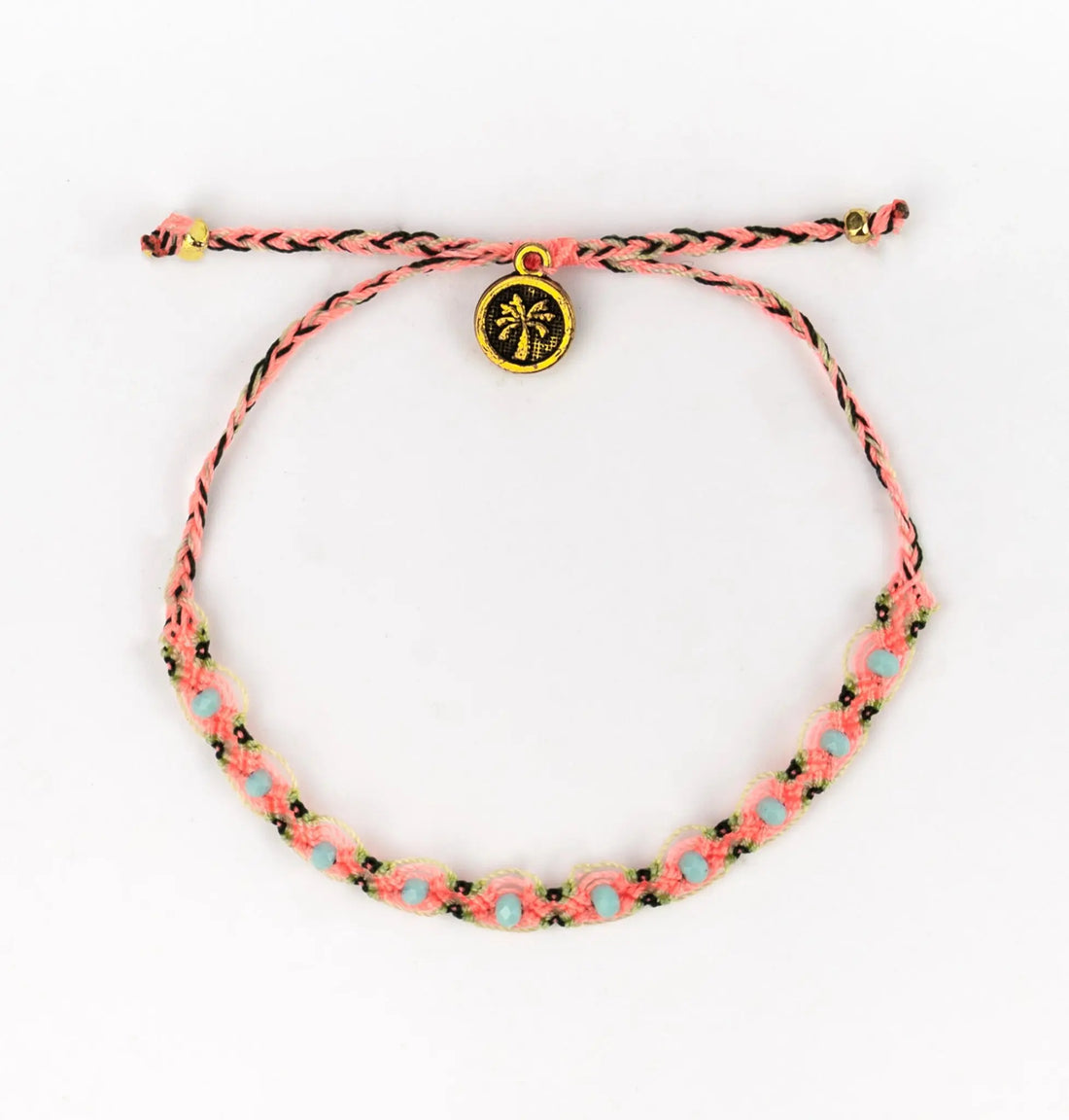 Pink and blue braided, handwoven bracelet featuring a gold palm tree charm, displayed against a white background—an eco-conscious jewellery piece inspired by Vermelha Surf Bracelets.