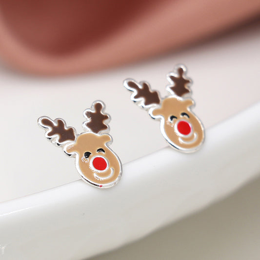 A pair of sterling silver reindeer earrings shaped as reindeer faces with brown antlers and red noses, set on a white surface—a delightful option for festive jewellery.
