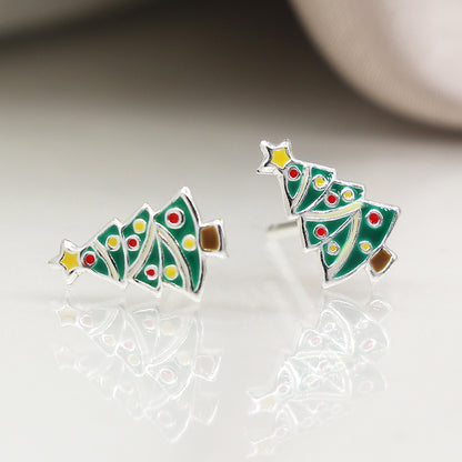 A pair of sterling silver Christmas tree earrings shaped like decorated trees with green enamel, colourful dots, a yellow star, and brown base—the perfect festive earrings for lovers of holiday jewellery.
