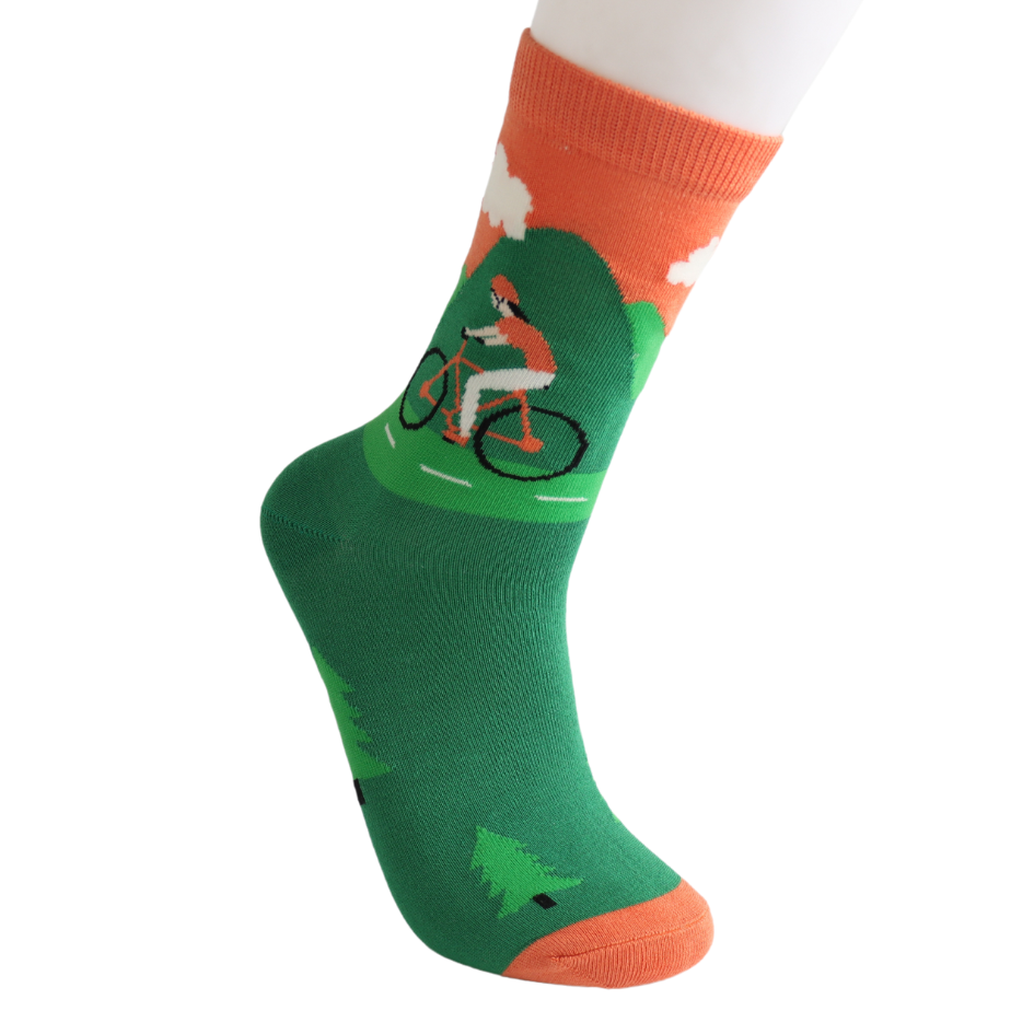 A green and orange sock featuring a person cycling through a natural scene with trees and clouds, crafted from sustainable bamboo fibres for vegan-friendly comfort.