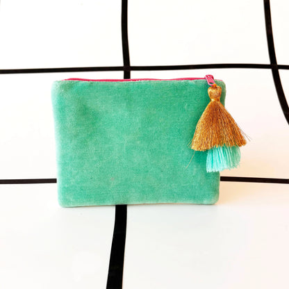 A small, rectangular mint green velvet Ey Up Duck pouch with a pink zip and gold and teal tassel, set against a white background with black grid lines—a delightful gift featuring classic British slang.