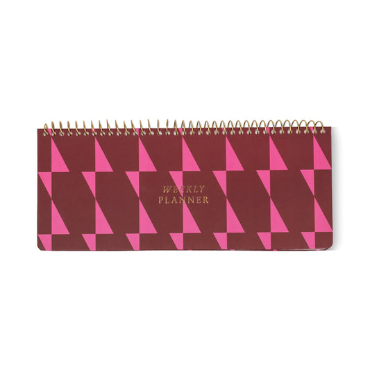 A spiral-bound Weekly Planner Pad featuring a maroon and pink geometric cover design, with gold lettering that reads WEEKLY PLANNER—ideal as a planner for professionals.