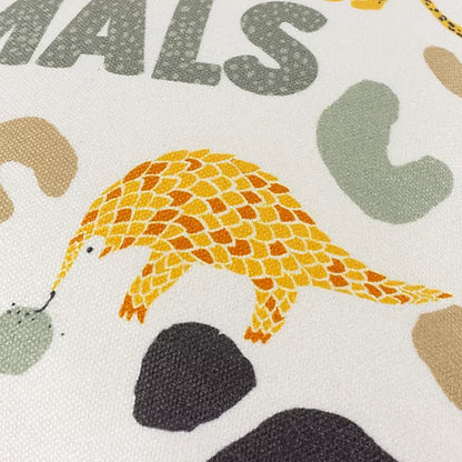 Illustration of a yellow and orange pangolin on a white background with grey and beige abstract shapes, ideal for wildlife décor or as an unusual animal cushion design. Partial text reading ANIMALS appears above it.