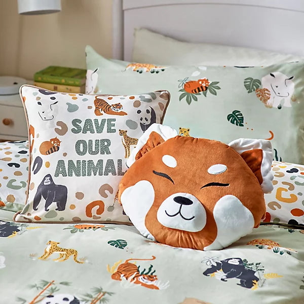 Decorative cushions on a bed, including a wildlife cushion with ‘Save Our Animals’ text and animal illustrations, alongside an orange animal face cushion and coordinating animal-themed bedding.