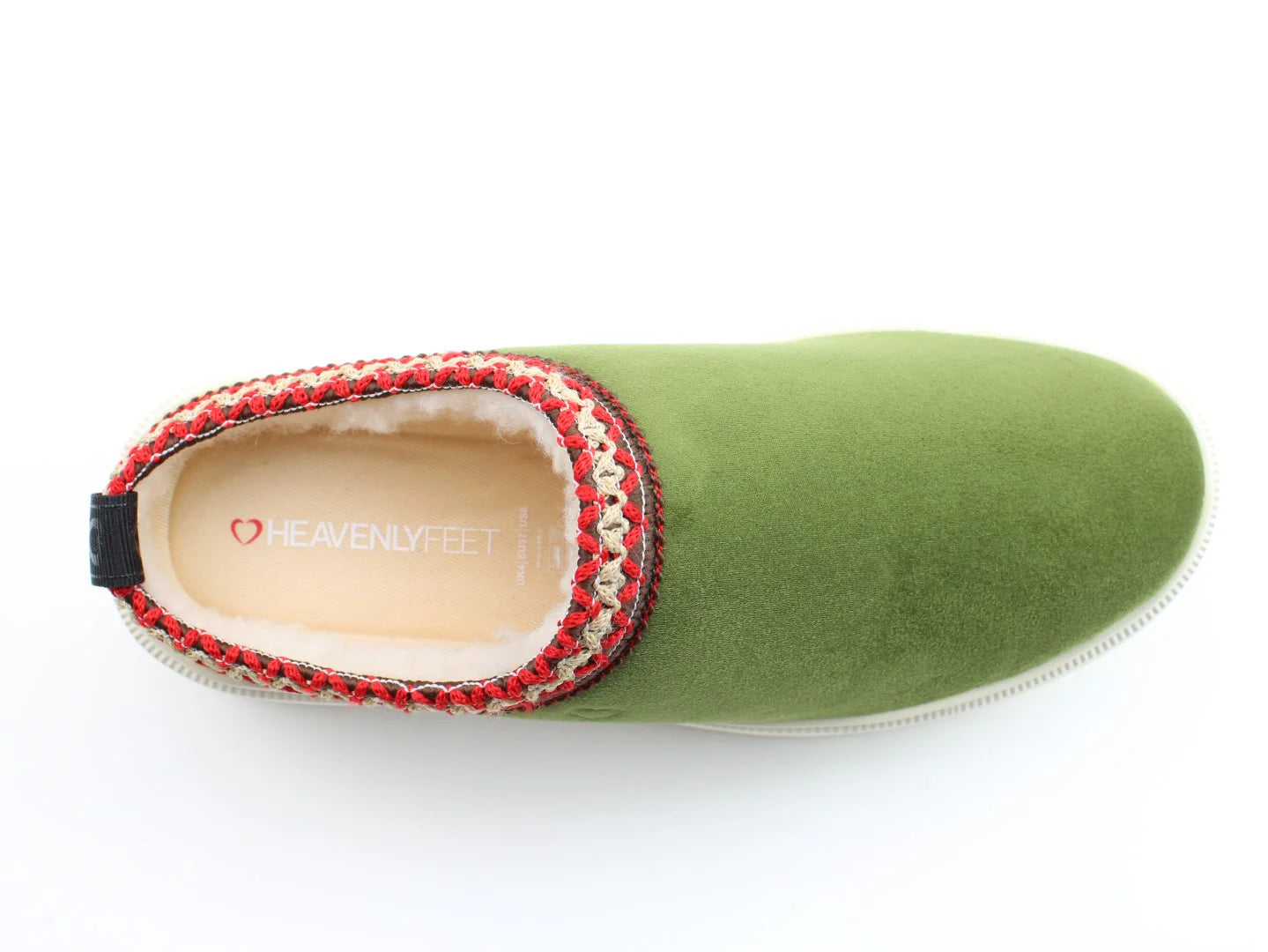 Green slipper with a white sole and multicoloured woven trim around the opening, part of the Vegan Friendly Range. The insole reads Heavenly Feet with a small heart logo, offering comfort that feels like Francas gentle touch.