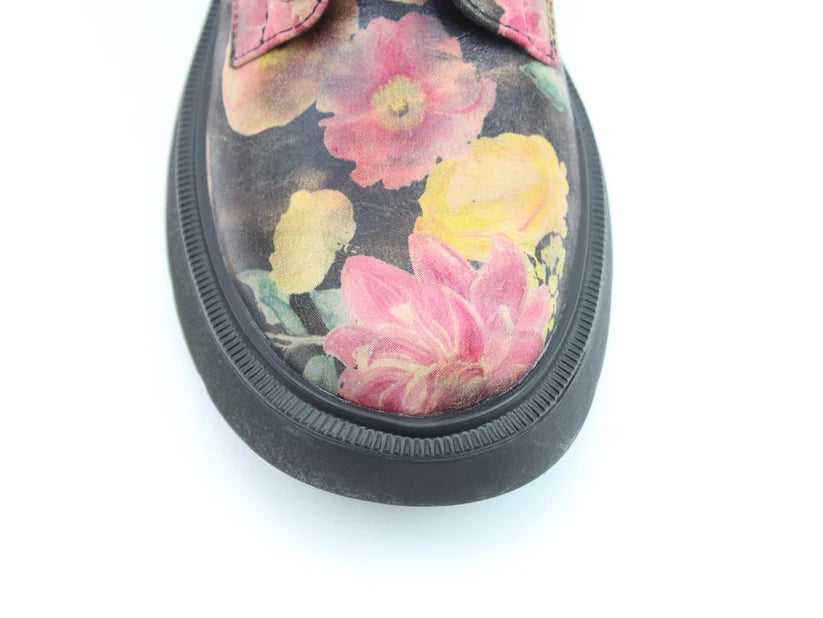 Close-up of the toe of a floral boot with a black sole and colourful upper pattern, featuring a memory-foam insole for extra comfort, set against a white background.