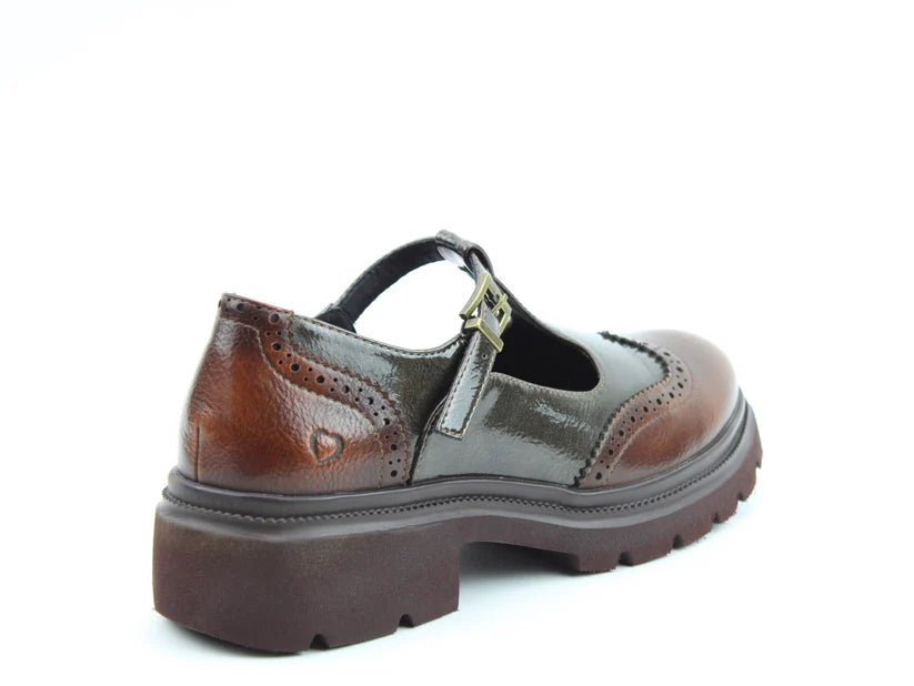 A brown leather Mary Jane shoe with a chunky sole, decorative perforations, and a buckle strap, featuring cushioned memory-foam insoles, displayed against a white background.