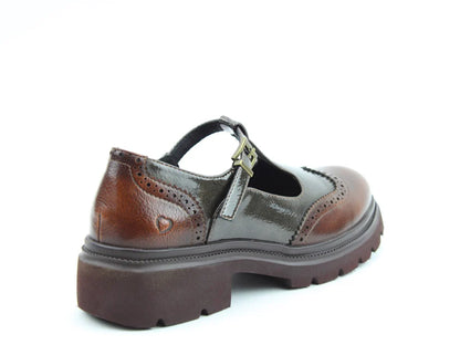 A brown leather Mary Jane shoe with a chunky sole, decorative perforations, and a buckle strap, featuring cushioned memory-foam insoles, displayed against a white background.