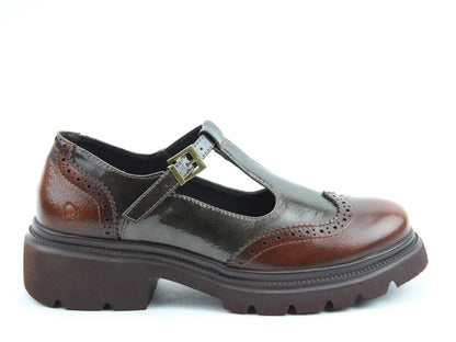 Brown leather Mary Jane shoe with brogue detailing, a buckle strap, and chunky sole, featuring memory-foam insoles for all-day comfort. Displayed in profile on a white background.