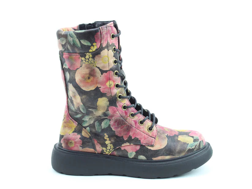 A side view of floral boots with a pink, yellow, and green print on black, featuring a thick sole and comfortable memory-foam insole.
