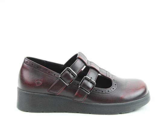 A single dark red Mary Jane vegan-friendly shoe with two buckle straps and a black wedge sole, shown in profile against a white background.