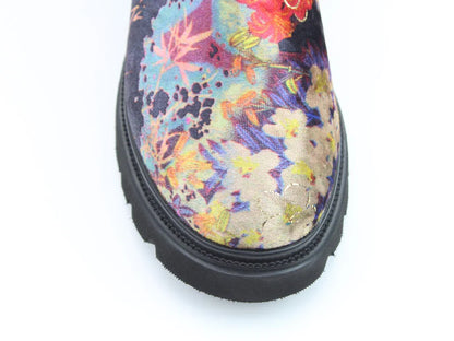 Close-up of the toe of the Zeta Black Floral Boots, showing a black sole and lively floral fabric pattern, made as vegan boots with a comfortable memory foam footbed.