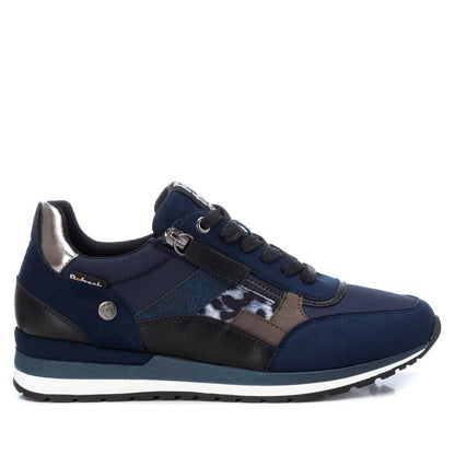 A navy blue athletic trainer with black, metallic silver, and leopard print details, featuring a white and blue-striped sole; these women’s vegan trainers have a removable insole and are PETA-certified vegan.