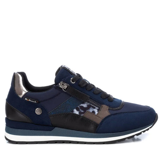 A navy blue athletic trainer with black, metallic silver, and leopard print details, featuring a white and blue-striped sole; these women’s vegan trainers have a removable insole and are PETA-certified vegan.