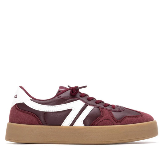 A maroon and white vegan trainer featuring a leather and suede upper, white side detailing, and a thick tan rubber sole, shown in side profile; PETA-certified and designed as non-slip footwear.