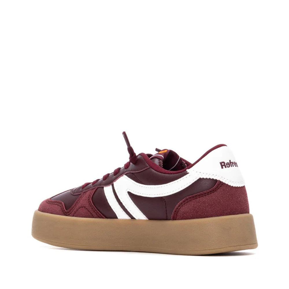 A maroon vegan trainer with white detailing, featuring a thick non-slip gum sole and the brand name Retro on the heel, shown in profile against a white background.