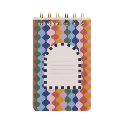 A small spiral-lined notebook with a colourful, wavy striped cover, high-quality paper, and a white arched label section featuring lines for writing.