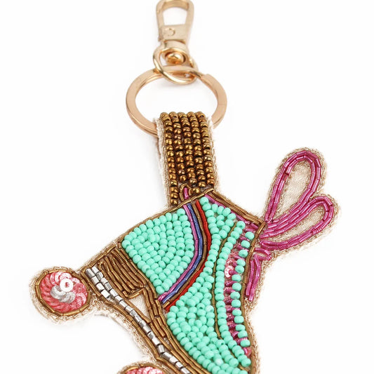 This vibrant Handmade Roller Skate Keyring is perfect for skaters and disco enthusiasts, featuring green, pink, and gold beads with a gold clip and ring.