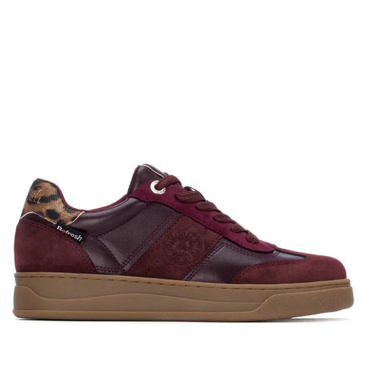 A burgundy trainer with a brown gum, non-slip sole, leather and suede panels, and a leopard print detail on the heel.