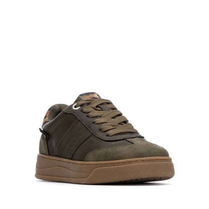 Olive green low-top trainer with suede and leather upper, matching laces, and a thick non-slip rubber sole, shown angled from the front left.