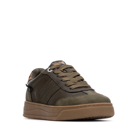 Olive green low-top trainer with suede and leather upper, matching laces, and a thick non-slip rubber sole, shown angled from the front left.