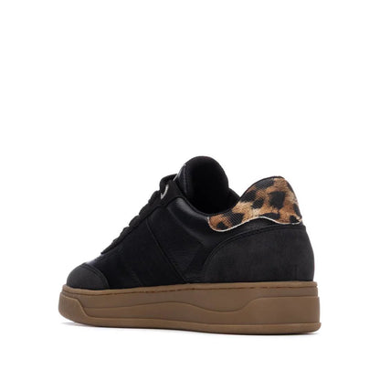 A black vegan trainer with a brown sole and a leopard print detail on the heel, seen from the back left side—stylish womens footwear perfect for any casual outfit.
