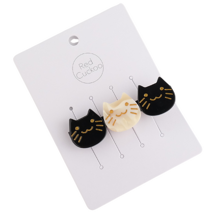 Three cat-shaped buttons, crafted in a black mix and sleek acetate finish—two black and one white—adorn a card labelled Red Cuckoo.