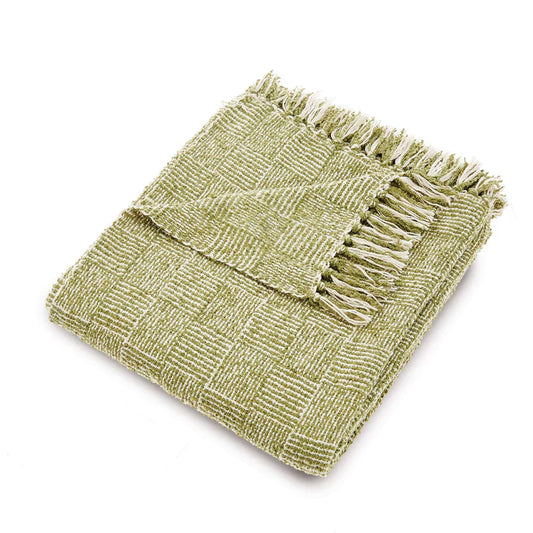 A folded green vegan woven throw with a chequered pattern and fringed edges.