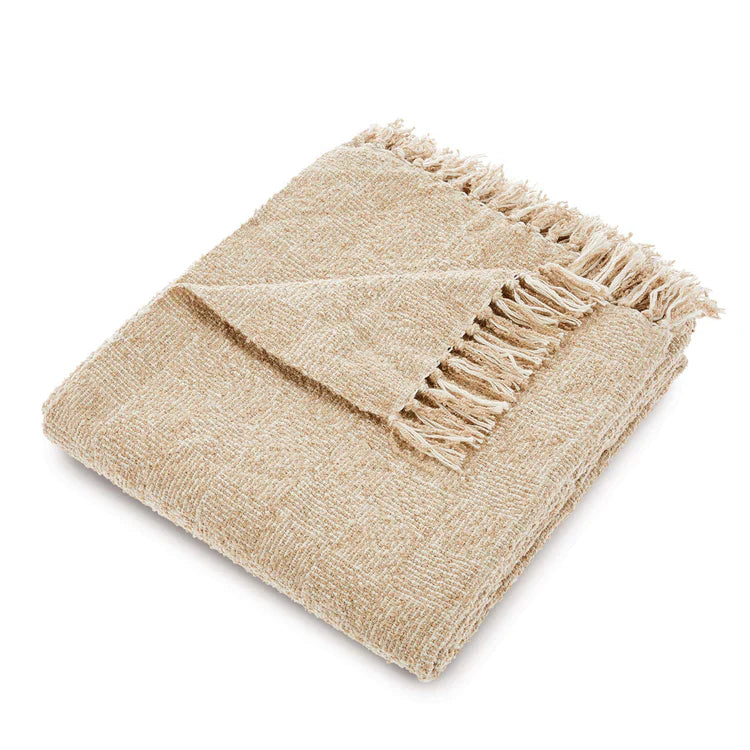 A folded beige Woven Cross Hatch Throw made from recycled bottles, with textured fabric and fringed edges, brings an eco-friendly accent to any white surface.