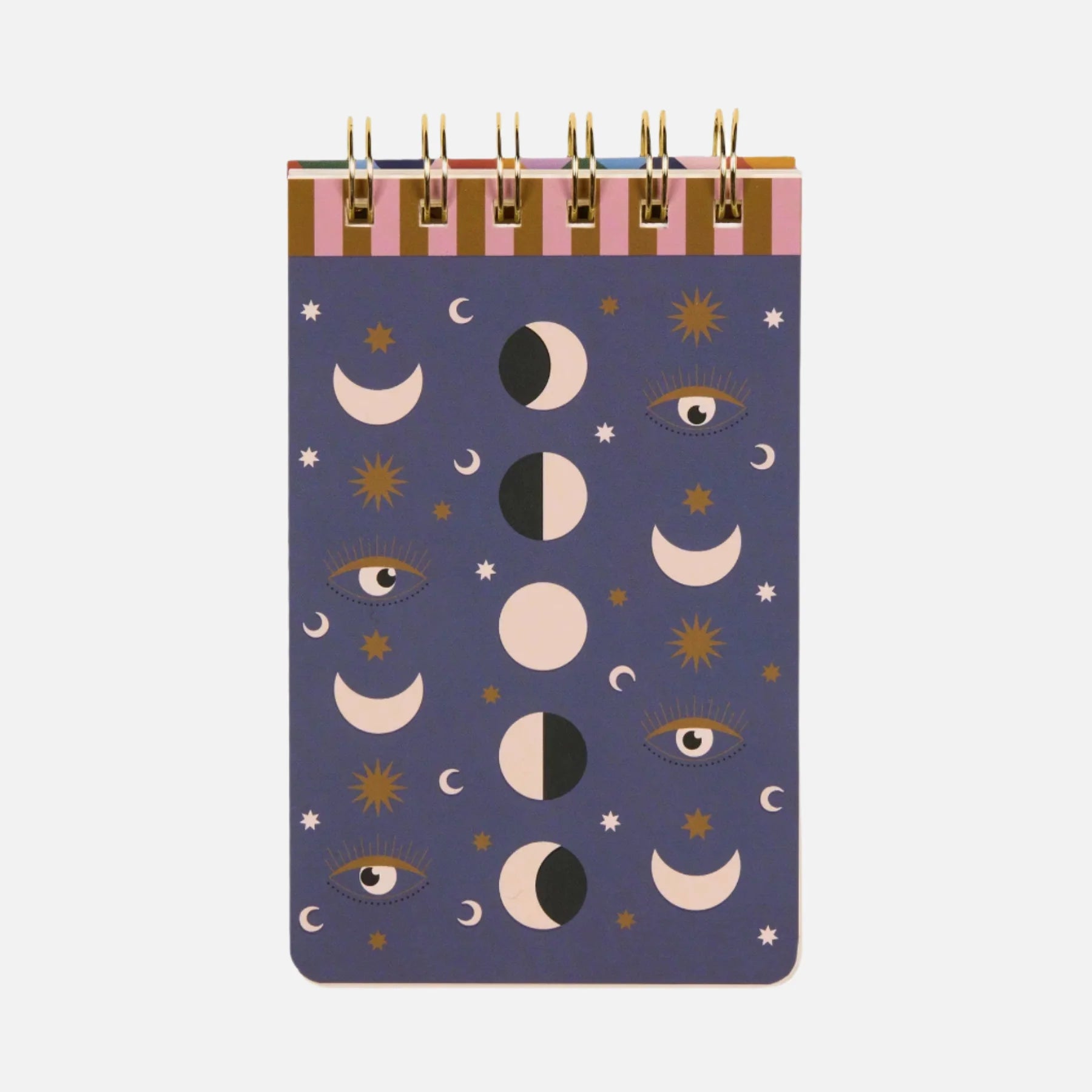 A spiral-bound celestial notebook with a purple cover, embellished with moon phases, stars, and eye illustrations in gold, black, and white.