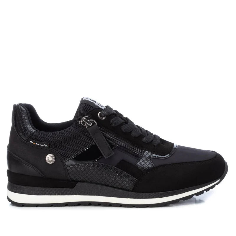 Black athletic trainer with laces, side zip, textured panels, white-accented sole, and a removable insole—these women’s vegan trainers are PETA-certified. Shown side-on against a white background.