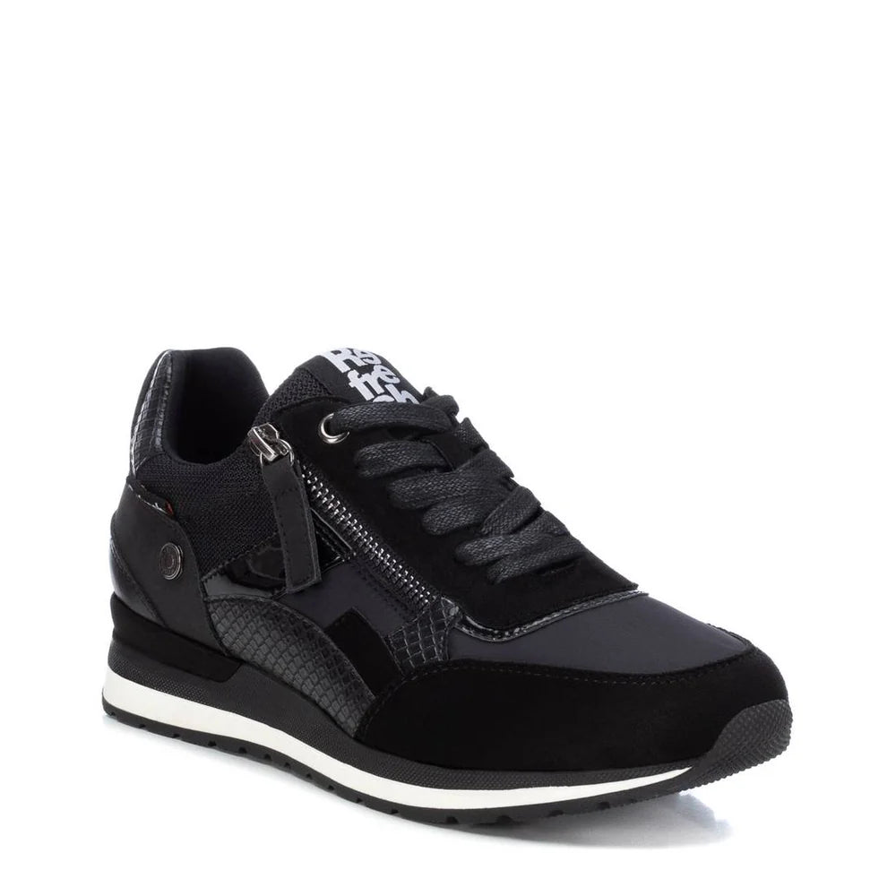 Black athletic trainer with textured and matte panels, lace-up front, side zip, white accent on the black sole, and a removable insole—these are women’s PETA-certified vegan trainers for all-day comfort.