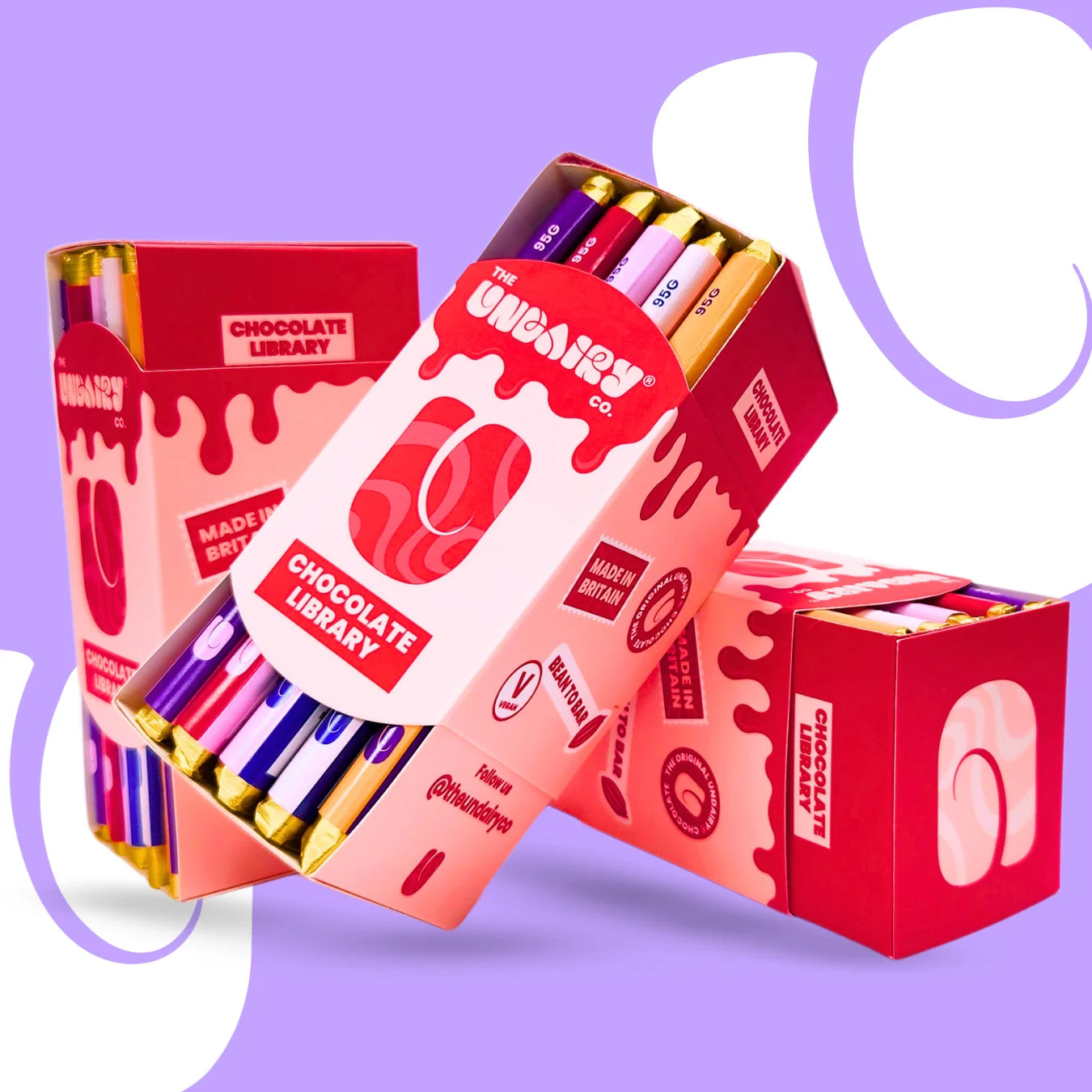 Three red and pink boxes labelled Chocolate Library contain colourful bars, including the Original Creamy bar and Fruit & Nut bar, stacked on a purple and white background with rounded shapes.