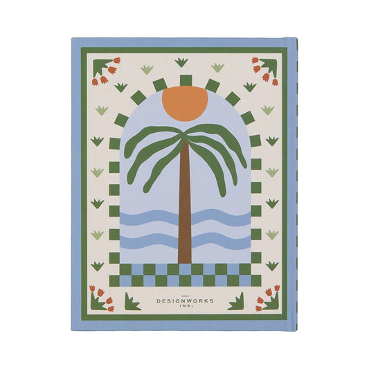 A pocket-sized hardback journal with a cover displaying a stylised palm tree, sun, and waves, bordered by geometric and floral patterns. The text DESIGNWORKS INK. appears at the bottom.