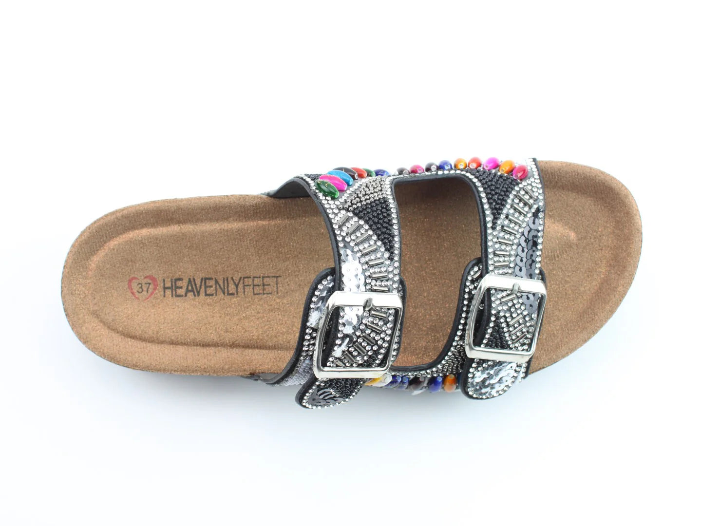 A sandal featuring a contoured footbed, two silver-buckled straps adorned with beads and patterns, crafted from vegan-friendly materials, with HEAVENLY FEET branding on the insole.